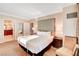 Bright bedroom featuring a king-size bed, upholstered headboard, and bathroom access at 125 E Harmon Ave # 1620, Las Vegas, NV 89109