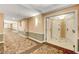 Long hallway featuring neutral walls with decorative carpets, lighting, and multiple entry doors for residential units at 125 E Harmon Ave # 1620, Las Vegas, NV 89109