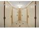 Hallway with two unit doors, tiled floors and ceiling light at 125 E Harmon Ave # 1620, Las Vegas, NV 89109