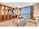 Comfortable living room with balcony and built-in media center featuring a flat-screen TV at 125 E Harmon Ave # 1620, Las Vegas, NV 89109