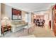 Open-concept living room featuring a cozy sofa, artwork, and a dining area with seating at 125 E Harmon Ave # 1620, Las Vegas, NV 89109