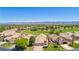Aerial view of home in golf course community with mature trees and desert landscape at 1253 Country Club Dr, Laughlin, NV 89029