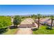 Aerial view of home featuring desert landscaping, mature trees, and golf course at 1253 Country Club Dr, Laughlin, NV 89029