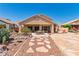 Spacious backyard with mature landscaping, rock feature, and patio at 1253 Country Club Dr, Laughlin, NV 89029