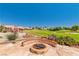 Backyard seating area with desert-friendly landscaping and golf course view at 1253 Country Club Dr, Laughlin, NV 89029