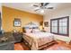Cozy bedroom with southwestern decor, ceiling fan, and shutters on the window at 1253 Country Club Dr, Laughlin, NV 89029