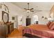 Bedroom with stained glass windows, ceiling fan and adjoining bathroom at 1253 Country Club Dr, Laughlin, NV 89029