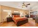 Spacious bedroom with stained glass windows, a ceiling fan, and tile floors at 1253 Country Club Dr, Laughlin, NV 89029