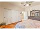 Comfortable bedroom with a ceiling fan, dresser with mirror, and a large closet at 1253 Country Club Dr, Laughlin, NV 89029
