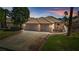 Charming single-story home with a tile roof, a two-car garage, and a well-manicured lawn at 1253 Country Club Dr, Laughlin, NV 89029