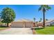 Charming single-story home featuring desert landscaping, mature trees, and large driveway at 1253 Country Club Dr, Laughlin, NV 89029