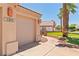 Attractive home exterior with a well-maintained lawn, palm trees and desert landscaping at 1253 Country Club Dr, Laughlin, NV 89029