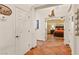 Hallway with tile flooring leading to a bedroom with a ceiling fan and a decorative headboard at 1253 Country Club Dr, Laughlin, NV 89029