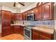 Kitchen features stainless steel appliances, granite countertops, and custom cabinetry at 1253 Country Club Dr, Laughlin, NV 89029