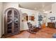 Stylish living room featuring a decorative cabinet, arched doorways, and a comfortable rocking chair at 1253 Country Club Dr, Laughlin, NV 89029