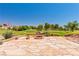 Enjoy outdoor living on this spacious patio with a built-in fire pit and views of a lush golf course at 1253 Country Club Dr, Laughlin, NV 89029