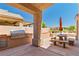 View of covered patio with BBQ, tiled benches, and outdoor kitchen overlooking golf course at 1253 Country Club Dr, Laughlin, NV 89029