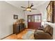 Cozy sitting area with leather chair, dark wood furniture, ceiling fan and private outdoor access at 1253 Country Club Dr, Laughlin, NV 89029
