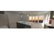 Modern kitchen with stainless steel appliances, an island with a sink, and access to outdoor views at 1280 S Yosemite Ave, Pahrump, NV 89048