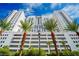 Upscale high-rise building featuring palm trees and a bright blue sky at 150 N Las Vegas Blvd # 1217, Las Vegas, NV 89101