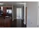 Hallway view of the entry door and access to the bedroom, hardwood flooring and stainless steel appliances at 150 N Las Vegas Blvd # 1217, Las Vegas, NV 89101
