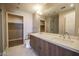 Bathroom featuring dual sinks, wood-grain cabinets and a separate water closet and shower at 150 N Las Vegas Blvd # 2302, Las Vegas, NV 89101