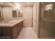 Bathroom featuring dual sinks, modern cabinets, sleek fixtures and a glass-enclosed shower at 150 N Las Vegas Blvd # 2302, Las Vegas, NV 89101
