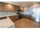 Modern kitchen with stainless steel appliances, tile backsplash, wood floors, and two-tone wood cabinets at 150 N Las Vegas Blvd # 2302, Las Vegas, NV 89101