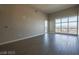 Open-concept living room featuring large windows, neutral walls, and hardwood floors at 150 N Las Vegas Blvd # 2302, Las Vegas, NV 89101