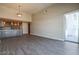 Bright living room with open floor plan and kitchen view, featuring hardwood floors and sliding glass door at 150 N Las Vegas Blvd # 2302, Las Vegas, NV 89101