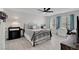 Spacious bedroom with ceiling fan, light-colored walls, and laminate wood flooring at 1575 W Warm Springs Rd # 1124, Henderson, NV 89014
