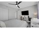Bright bedroom with a ceiling fan, TV, desk, and organized shelving for a tidy living space at 1575 W Warm Springs Rd # 1124, Henderson, NV 89014