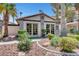 Clubhouse exterior featuring double doors, green landscaping, and desert rock at 1575 W Warm Springs Rd # 1124, Henderson, NV 89014
