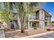 Two-story building with exterior stairs, balconies, and well maintained landscaping. Unit 11 at 1575 W Warm Springs Rd # 1124, Henderson, NV 89014