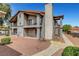 Well-maintained exterior of a two-story building with balconies and stairs, set in a landscaped area at 1575 W Warm Springs Rd # 1124, Henderson, NV 89014