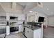 Modern kitchen with stainless steel appliances, white cabinetry, and gray countertops at 1575 W Warm Springs Rd # 1124, Henderson, NV 89014
