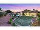Expansive backyard features a lush lawn, inviting pool, mature landscaping, and a covered patio for outdoor enjoyment at 1594 Pontine Ct, Henderson, NV 89052