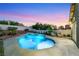 Beautiful backyard boasts a custom pool and spa, patio area, and mature landscaping for outdoor living at 1594 Pontine Ct, Henderson, NV 89052