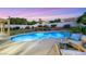 Relax in the backyard with pool, spa, patio and an outdoor seating area, surrounded by lush landscaping at 1594 Pontine Ct, Henderson, NV 89052