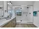 Modern bathroom with double sinks, beautiful countertops, and a sleek glass-enclosed shower at 1594 Pontine Ct, Henderson, NV 89052