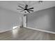 Bedroom with neutral walls, wood floors, ceiling fan, and white trim, creating a calming and inviting space at 1594 Pontine Ct, Henderson, NV 89052