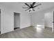 Bedroom with wood flooring, ceiling fan, closet with sliding doors and a doorway leading to an additional room at 1594 Pontine Ct, Henderson, NV 89052