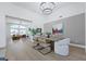 Open-concept dining room featuring a modern chandelier, rustic table and chairs, open to the living area at 1594 Pontine Ct, Henderson, NV 89052