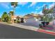 An inviting home featuring desert landscaping, a three-car garage, and a tile roof at 1594 Pontine Ct, Henderson, NV 89052