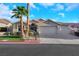 A well-maintained home featuring desert landscaping, a three-car garage, and a tile roof at 1594 Pontine Ct, Henderson, NV 89052