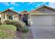 A well-maintained home featuring desert landscaping, a tile roof, and an iron gate entry at 1594 Pontine Ct, Henderson, NV 89052