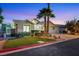 A home featuring desert landscaping, a three-car garage, and exterior lighting at 1594 Pontine Ct, Henderson, NV 89052