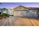 A well-maintained home featuring desert landscaping, a tile roof, and a three-car garage at 1594 Pontine Ct, Henderson, NV 89052