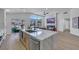 Kitchen featuring island with seating, stainless appliances, and an open floor plan leading to the living area at 1594 Pontine Ct, Henderson, NV 89052