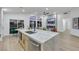 Kitchen featuring an island with seating, stainless appliances, and an open floor plan leading to the living area at 1594 Pontine Ct, Henderson, NV 89052